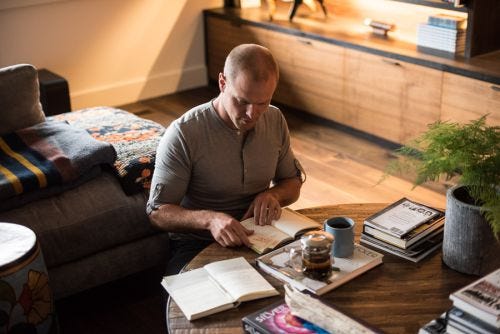 A person reading book on table